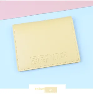 Detail of yellow PU leather household register cover with reinforced stitching and embossed text