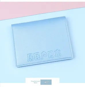 Macro shot of pearl blue leather document cover with textured grain and neat stitching