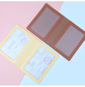 Detail of brown and yellow leather document folders with clear internal card slots