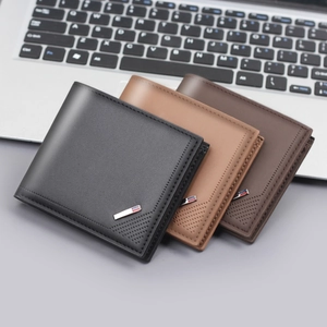 Classic men's bi-fold leather wallet in black and brown, business style on keyboard