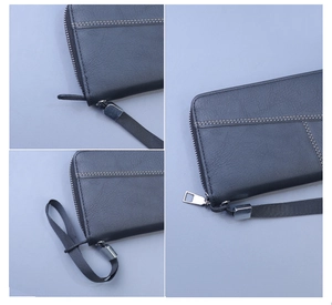 Macro detail of black leather wallet stitching, zipper closure and wrist strap