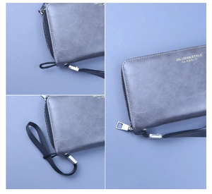Détails de la pochette en cuir ciré bleu-gris avec fermeture éclair et dragonne noire