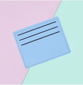 Close-up of slim light blue leather card holder with three card slots on pastel background