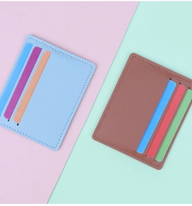 Top view of ultra-slim card holders in blue and brown leather with fine stitching