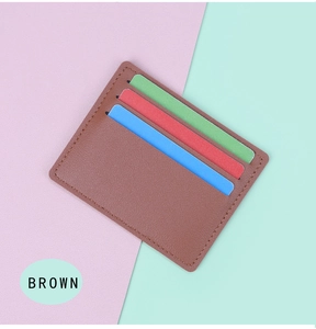 Detail view of ultra-thin brown leather card holder with three slots on colorful background