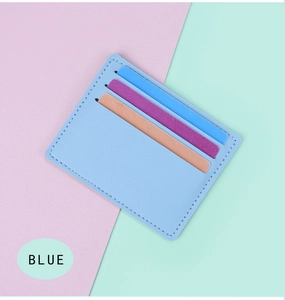 Close-up of slim light blue card holder with three vertical slots and neat stitching
