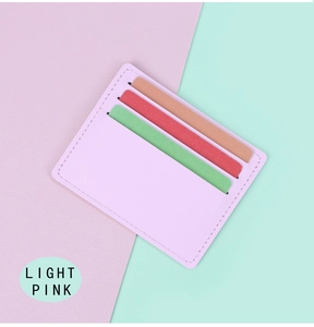 Detail view of light pink ultra-slim card holder showing three slots and fine stitching
