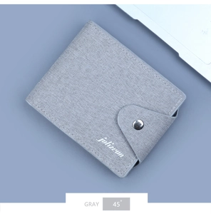 Close-up of gray canvas wallet featuring a snap button and textured fabric finish
