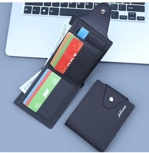Detail of black canvas bifold wallet featuring snap button and multiple card slots