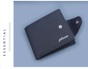 Macro detail of dark blue canvas wallet with white logo, silver snap button and stitching