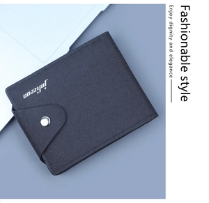 Detailed view of durable navy blue canvas men's wallet with metal snap button and logo
