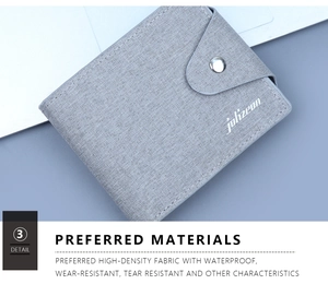 Detail view of grey canvas wallet featuring waterproof fabric and silver snap closure