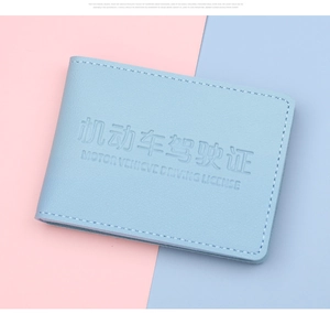 Detailed view of light blue leather driver's license holder with embossed lettering and stitching