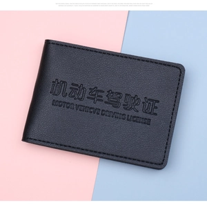 Close-up of black lychee grain leather driver's license cover with embossed lettering