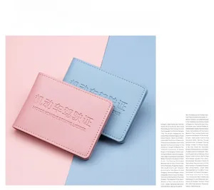 Close-up of pink and blue faux leather driver license holders with lychee texture