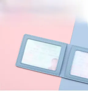 Close-up of light blue leather card holder showing durable double-stitched reinforced edges