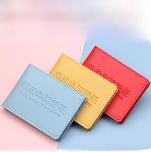Macro view of blue, yellow, and red PU leather driving license covers with embossed text