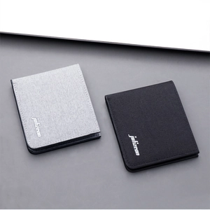 Close-up of minimalist slim canvas wallets in light grey and black with two-fold structure