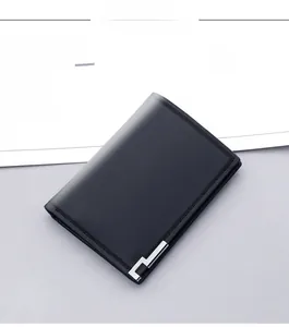 Detailed close-up of a black vertical men's wallet with fine texture and silver metal trim
