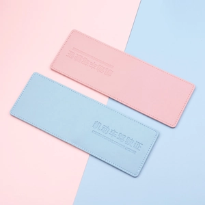 Pink and blue leather driving license covers with embossed text on textured finish