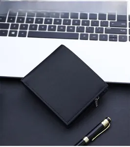 Close-up of black leather bifold wallet with zipper on office desk with laptop