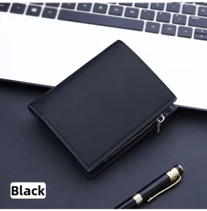 Detailed view of a black leather zip-around wallet on a desk next to a pen and keyboard
