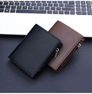 Detail of bifold wallets in black and brown leather with metal zippers and stitching