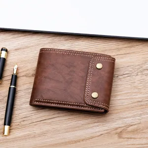 Detail of vintage brown oil wax leather wallet with retro snaps and white stitching