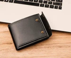 Detail of black oil wax leather men's wallet with white stitching and retro metal rivets