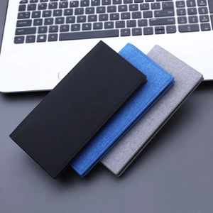 Long canvas wallet for men in black blue and grey displayed on office desk