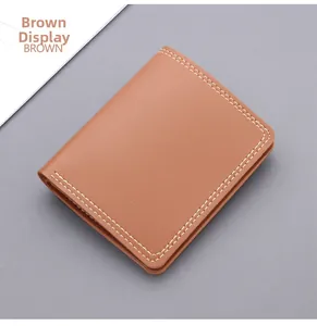 Detailed close-up of brown textured leather wallet with white double-row stitching detail