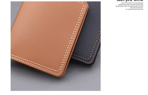Detail of litchi grain leather texture and white stitching on brown and black wallets