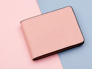 Detail of pink bifold driver license holder with lychee texture and contrast stitching