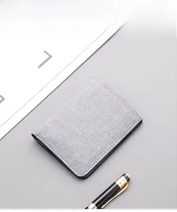Detail view of ultra-thin grey canvas wallet with fine stitching and card slots