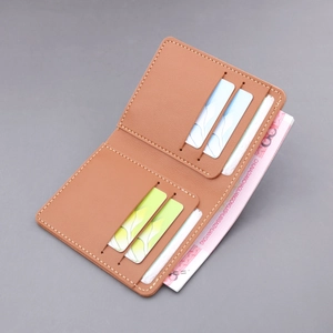 Slim tan leather bifold wallet for men with visible stitching and multiple card slots
