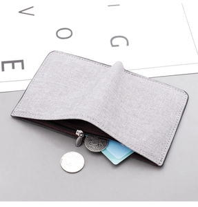 Detail view of a gray canvas vertical wallet with zipper and clear fabric texture