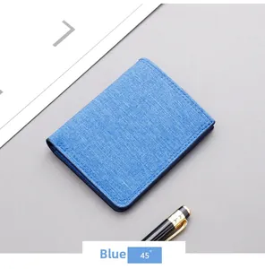 Detailed 45-degree view of blue canvas slim wallet for men with textured fabric finish