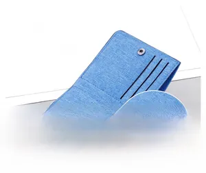 Detail view of the durable blue canvas wallet featuring a secure silver metal snap button