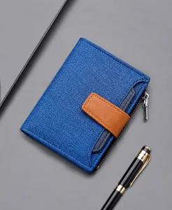 Detail view of a blue canvas wallet for men featuring a brown leather strap and side zipper
