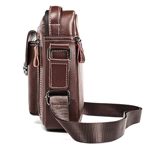Side view of a brown genuine leather shoulder bag for men with silver metal zippers