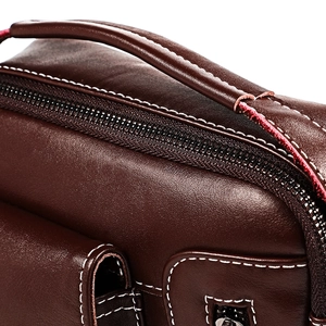 Men's dark brown leather shoulder bag featuring white contrast stitching and round handle