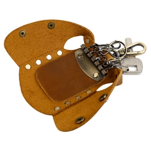 Macro detail of handmade genuine leather key wallet with antique bronze six-key hardware