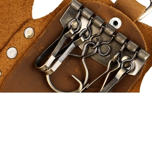 Detail of 6 vintage bronze hooks and textured brown genuine leather inside the key wallet