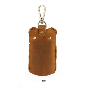 Detail view of the back of a brown leather key pouch with a vintage brass metal clasp
