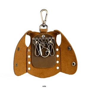 Detail view of leather key case interior featuring 6 metal hooks and brown litchi grain leather