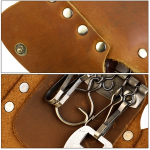 Detail view of brown vintage leather key case with metal snap and bronze hooks