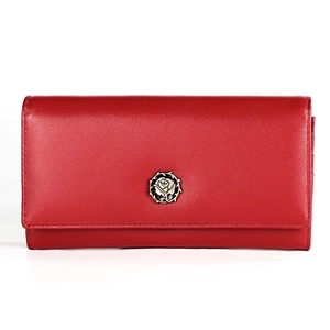 Close-up of red leather wallet featuring a delicate gold rose metal emblem detail