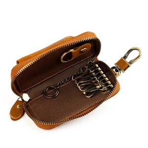 Internal view of brown leather key case with six bronze hooks and a sturdy zipper