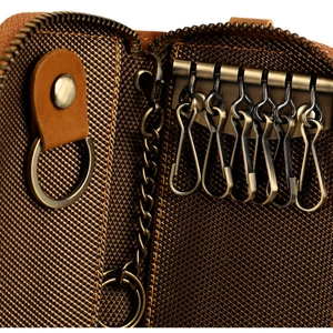 Detail view of leather key case interior with six bronze metal hooks and a large ring