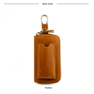 Detail of vintage camel leather key pouch with rustic metal hook and precise stitching